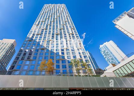 11 Hoyt Street nel centro di Brooklyn è un condominio residenziale con una facciata bianca ondulata unica di pannelli in cemento prefabbricati e un campo automobilistico. Foto Stock