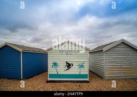 Capanna dipinta sulla spiaggia di ciottoli di Hayling Island con 'la vita è migliore alla spiaggia' dipinta su di essa. Foto Stock