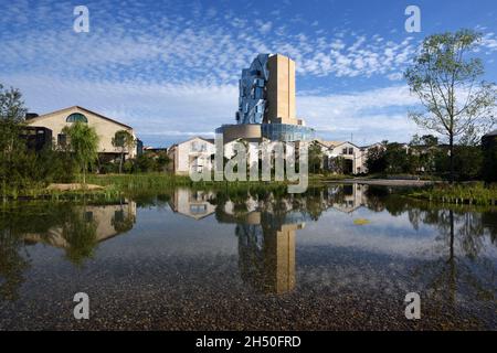 TORRE LUMA, Art Gallery & Arts Centre, progettato da Frank Gehry, si riflette in piscina NEL GIARDINO FONDAZIONE LUMA Arles Provence Francia Foto Stock