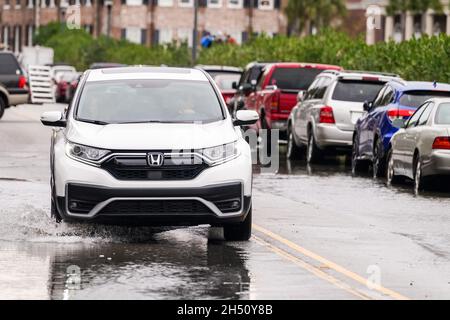 Charleston, Stati Uniti. 05 novembre 2021. Un SUV attraversa le acque alluvionali lungo East Battery Street dopo che le alluvioni del tempo secco hanno colpito il centro storico 5 novembre 2021 a Charleston, South Carolina. Il cambiamento climatico e l'aumento del livello del mare hanno aumentato le inondazioni di 10 volte negli ultimi dieci anni lungo la costa di Charleston. Credit: Richard Ellis/Richard Ellis/Alamy Live News Foto Stock