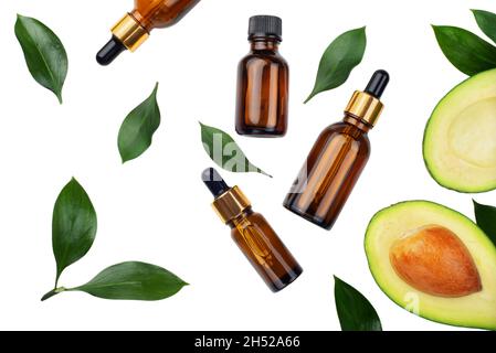 Flaconi contagocce con avocado fresco maturo e olio essenziale su tavola bianca piatta Foto Stock