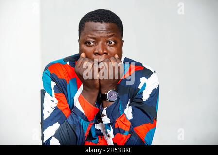 bel giovane uomo d'affari scioccato e coprendo la bocca con le mani per errore Foto Stock