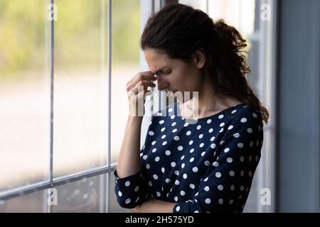 Stressato latino femmina grimace toccare fronte cercare di ricordare qualcosa Foto Stock