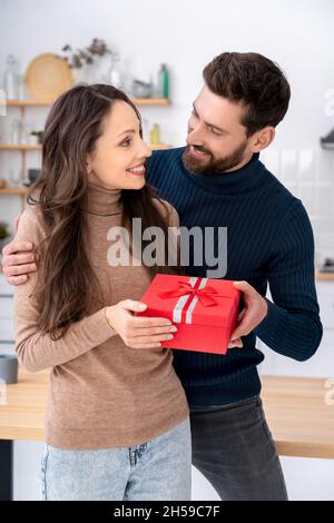 L'uomo che dà la donna scatola del regalo che si congratula con il compleanno, l'anniversario o il Natale Foto Stock