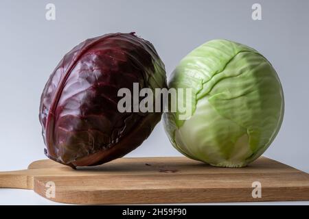 Il cavolo bianco e rosso sul tagliere di legno prepara la cottura Foto Stock