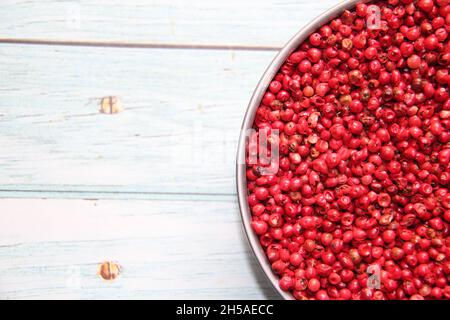 Pepe rosa: Nomi di aroeira-Red, aroeira-pementeira o rosa-poivre della specie Schinus terebinthifolia, (Anacardiaceae). In una ciotola. Vista dall'alto . Foto Stock