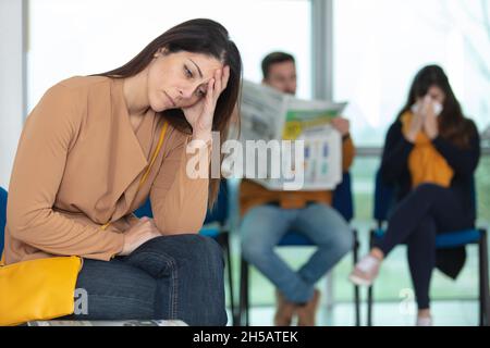 donna ansiosa in una sala d'attesa Foto Stock