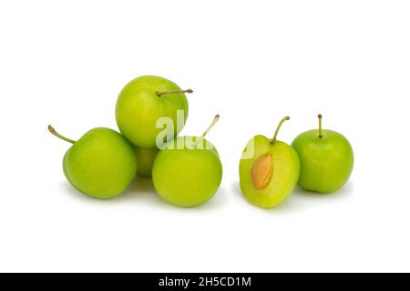 Prugne intere e mezzo verdi su fondo bianco isolato Foto Stock