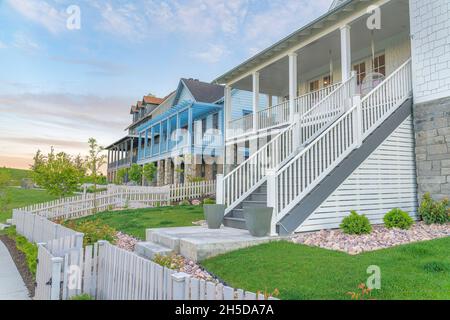 Tre grandi case con recinzione di picket bianco e verande all'ingresso di Daybreak, Utah Foto Stock