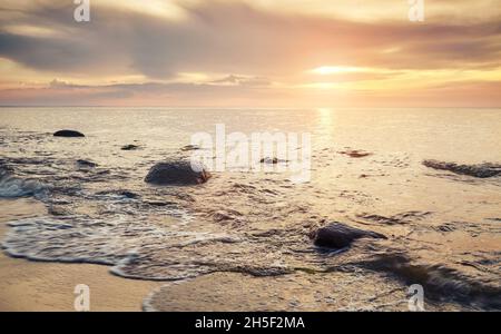 Tramonto d'oro sulla spiaggia di Miedzyzdroje, Polonia. Foto Stock