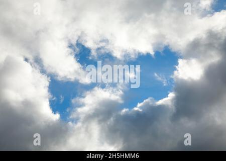 Le nuvole di stratocumuli e le finestre blu del cielo formano una spettacolare formazione di nubi nel cielo durante la tempesta di Foehn Foto Stock