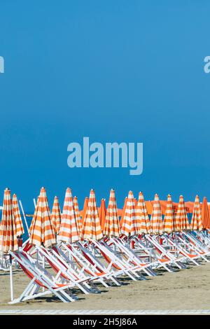 Ombrelloni e sdraio in fila su una spiaggia di Viareggio, Toscana, Italia. Foto Stock