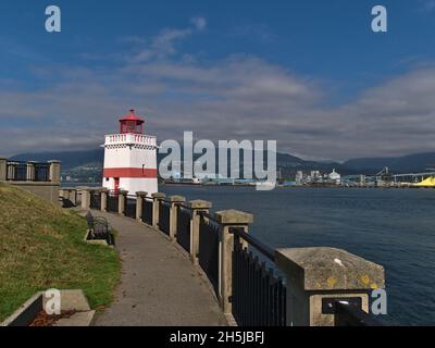 Vista del Seawall in Stanley Park con il faro di Brockton Point dipinto di bianco e rosso nella giornata di sole in autunno a Vancouver, British Columbia, Canada. Foto Stock