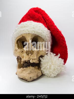 cranio umano con cappuccio di elfo isolato su sfondo nero Foto Stock