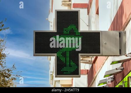 Croce elettronica di farmacia verde con il simbolo del serpente nella tazza di Hygieia Foto Stock