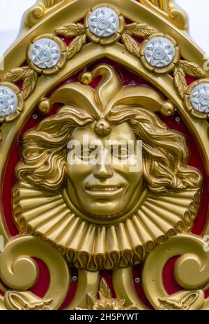 faccia dipinta d'oro su un percorso d'epoca, attrazione del terreno fieristico con faccia dorata, rilievo stampato in rilievo stampato in oro sulla ruota in ferro. Foto Stock