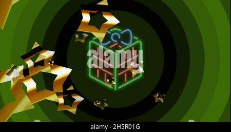 Immagine delle stelle che cadono sopra il presente di natale del neon e i cerchi verdi Foto Stock