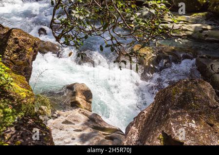 Parco Nazionale di Fiordland. Un flusso tempestoso che scompare in un imbuto. Asm. Imbuto Ruscello tra le pietre. South Island, Nuova Zelanda. Foto Stock