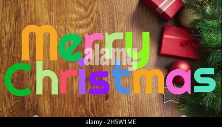 Immagine di buon testo di natale sopra i regali Foto Stock