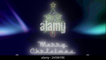 Immagine di buon testo di natale su aurora e albero di natale Foto Stock