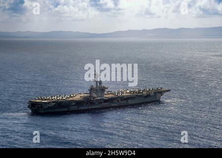 Mar delle Filippine, Stati Uniti. 11 Nov 2021. Il portaerei USS Carl Vinson della Marina statunitense di classe Nimitz transita nel Mare delle Filippine sulla strada per Guam per una visita al porto, il 11 novembre 2021 a Guam, USA. Credit: MC2 Haydn N. Smith/Planetpix/Alamy Live News Credit: Planetpix/Alamy Live News Foto Stock