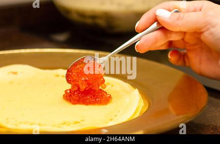 Frittelle tradizionali russe con caviale rosso, su un piatto. Cucina russa. Vista laterale. Settimana di pancake. Concetto di cibo sano. Foto Stock