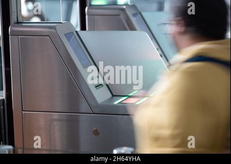 08 novembre 2021, Hessen, Francoforte sul meno: Una donna attraversa una barriera nell'area di imbarco dell'aeroporto di Francoforte. Foto: Sebastian Gollnow/dpa Foto Stock