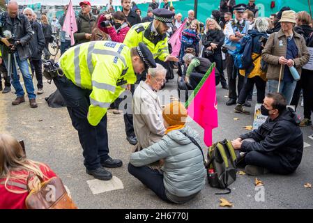 I manifestanti del cambiamento climatico tentano di bloccare il Lord Mayor's Show, la sfilata, la processione, Londra, Regno Unito. Seduta su strada di percorso sfilata. Polizia Foto Stock