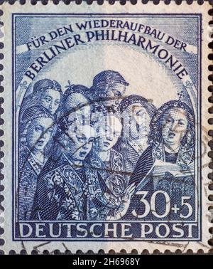 GERMANIA, Berlino - CIRCA 1950: Un francobollo dalla Germania, Berlino mostrando angeli cantanti (estratto dalla pala di Gand) e il testo: Per i recons Foto Stock