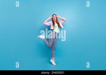 Intera lunghezza corpo foto ragazza overjoyed indossando abiti casual ballando in vetro solare isolato colore blu pastello sfondo Foto Stock