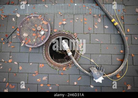 Itzehoe, Germania. 9 novembre 2021. Un tubo flessibile utilizzato per fornire olio di riscaldamento a un cliente in un edificio di appartamenti è fissato al beccuccio di riempimento di un serbatoio di stoccaggio sotterraneo. Credit: Christian Charisius/dpa/Alamy Live News Foto Stock