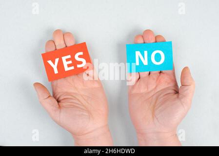 Carta in rosso e blu, con le parole sì e no, comunicazione simbolo, business concept, minimalismo Foto Stock