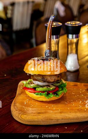 Verticale di un delizioso hamburger servito in un caffè Foto Stock