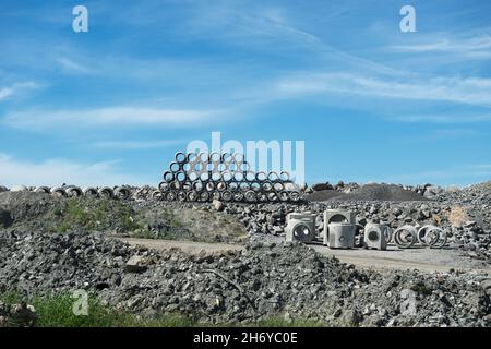 Cantiere di costruzione con tubi di cemento impilati sullo sfondo Foto Stock