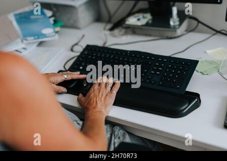 Le mani della donna che usano il computer Foto Stock