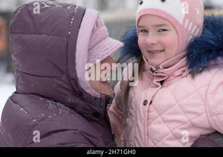 Sorridendo anziana signora abbracciò la nipote nel primo piano d'inverno Foto Stock