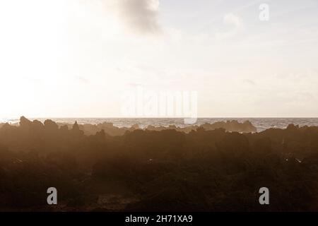 Grandi onde che si infrangono su roccia vulcanica nera sull'Oceano Atlantico nella costa di Faja Grande, l'isola di Flores, Azzorre, Portogallo Foto Stock