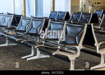 Area d'attesa vuota del terminal aeroportuale con posti a sedere nella lounge delle partenze Foto Stock