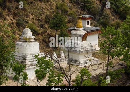 Uno stupa buddista in stile nepalese, uno stupa in stile tibetano e un coro in stile bhutanese a Chhuzom, Bhutan. Foto Stock