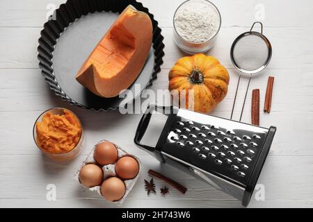 Piatto da forno e ingredienti per torta di zucca su sfondo bianco Foto Stock