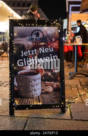 20 novembre 2021, bassa Sassonia, Lüneburg: "Ora VIN brulé" è scritto su un cartello non lontano dal mercato di Natale sulla piazza del municipio. L'odore di bratwurst e mandorle dovrebbe attirare i visitatori nella città vecchia di Lüneburg da mercoledì (24 novembre) in poi. Allestendo le bancarelle, la città anseatica vuole implementare il concetto di Lüneburg come città di Natale. Deve essere applicata la regola 2G. Foto: Philipp Schulze/dpa Foto Stock