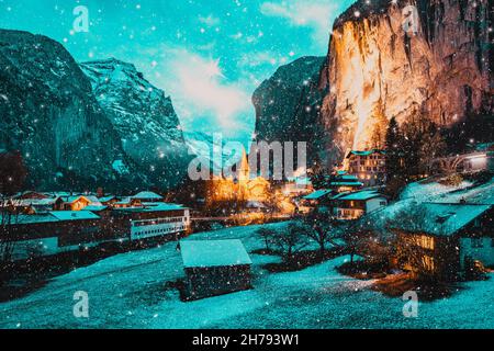 incredibile villaggio turistico alpino di notte in inverno con famoso chiesa e cascata di Staubbach Lauterbrunnen Svizzera Europa Foto Stock