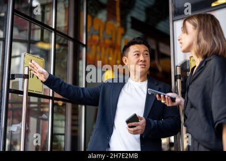 Donna e uomo che bevono cocktail al caffè Foto Stock