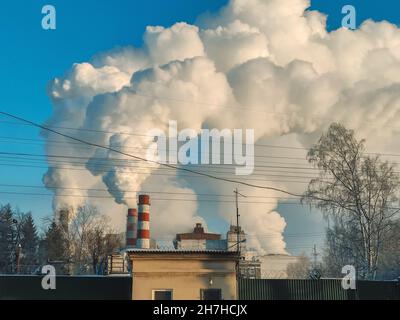 Enormi nubi di fumo da camini, tubi di una centrale termica, inquinando l'atmosfera inquinamento atmosferico da camini di centrale. Emissione di camino Foto Stock