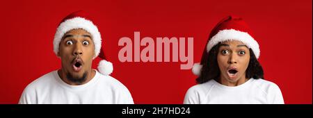 Primo piano di emotivo uomo nero e donna in Babbo Natale cappelli Foto Stock