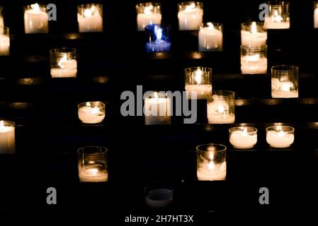 Candele accese nella chiesa per le preghiere. Foto Stock