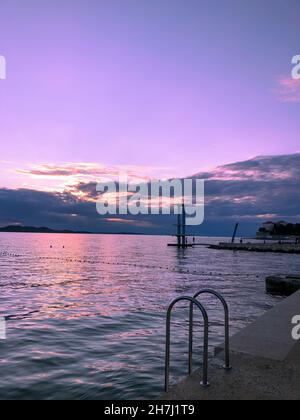 Tramonto rosa sul mare Adriatico Foto Stock