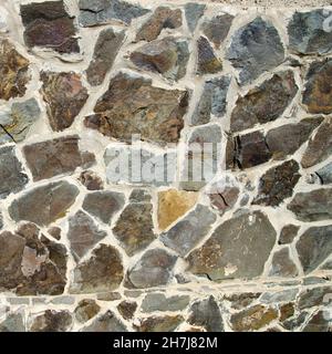 Muro di pietra fatta di pietre naturali Foto stock - Alamy