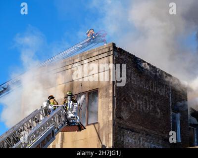 Oak Park, Illinois, Stati Uniti. 23rd novembre 2021. I vigili del fuoco combattono un incendio in più su Lake Street, nel quartiere commerciale del centro di questo sobborgo vicino a Chciago. Si pensa che il fuoco sia iniziato nella cucina di Delia's Kitchen, un popolare locale da pranzo, ma questo non è certo. Foto Stock