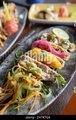 Primo piano verticale di deliziosi tacos disposti splendidamente su un piatto Foto Stock